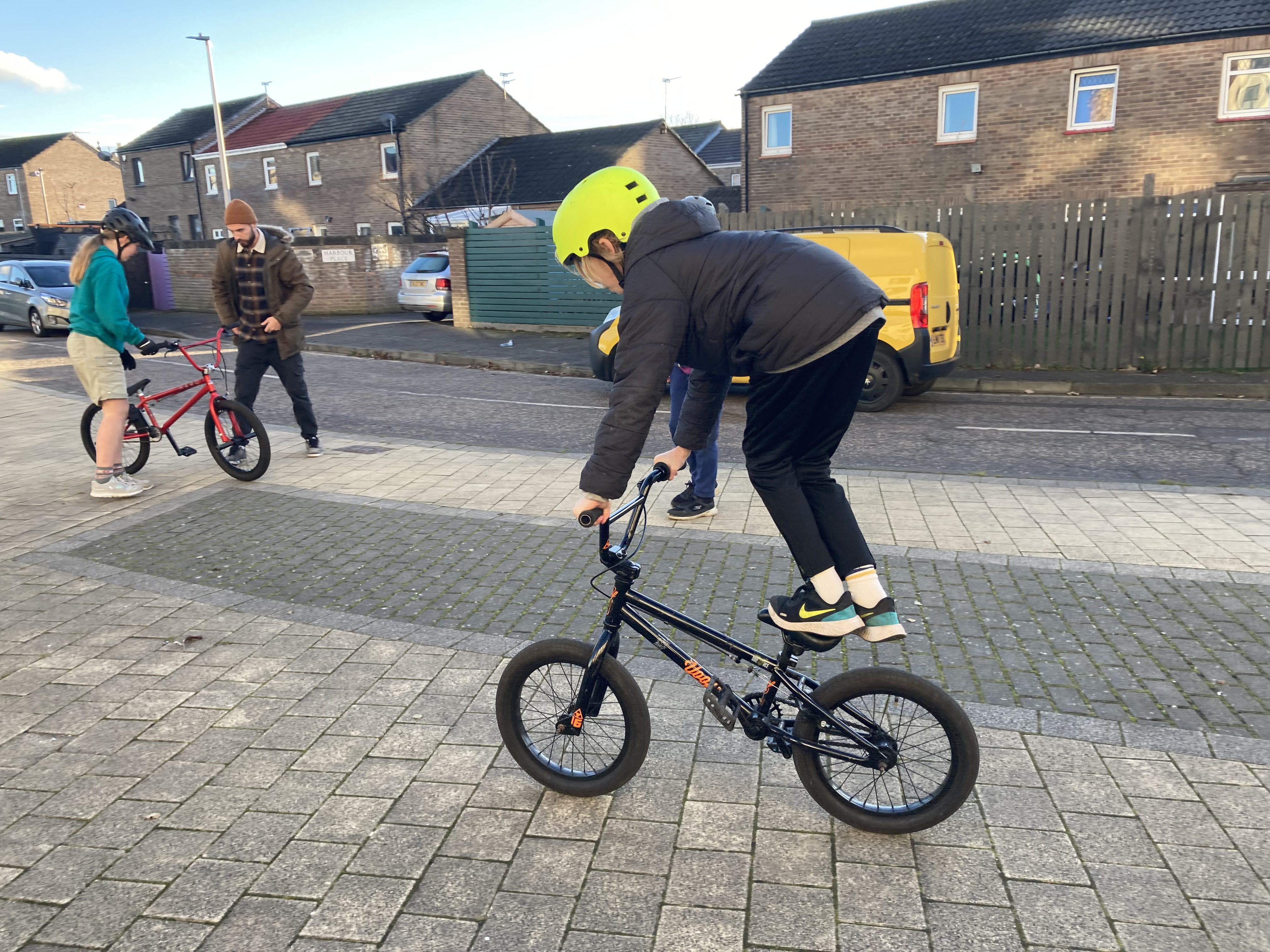 Children learning bmx tricks